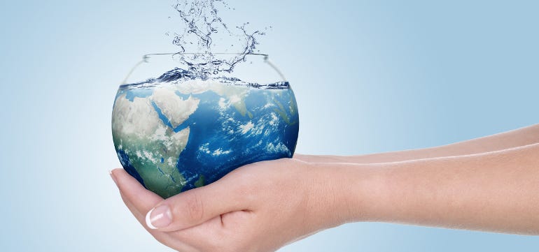 Hands gently holding a glass bowl filled with water shaped like the Earth, with water splashing from the top — symbolizing global hydration and water conservation. On Take Water emphasizes the importance of clean water for a healthier planet.

