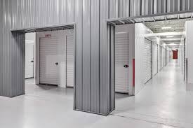 "Clean and organized indoor self-storage facility with multiple secure metal storage units and white roll-up doors."









Ask ChatGPT
