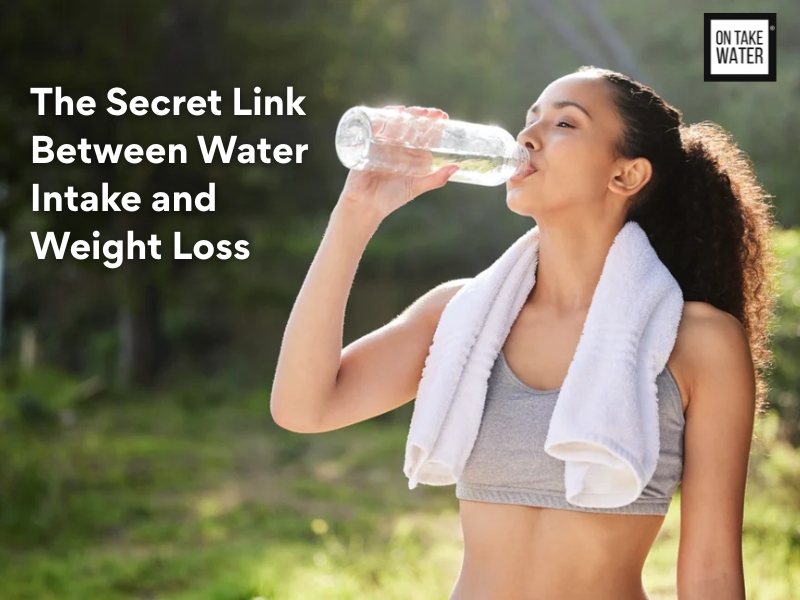A fit woman in sportswear with a towel around her neck drinks water from a clear bottle outdoors, promoting the On Take Water message about hydration and weight loss.