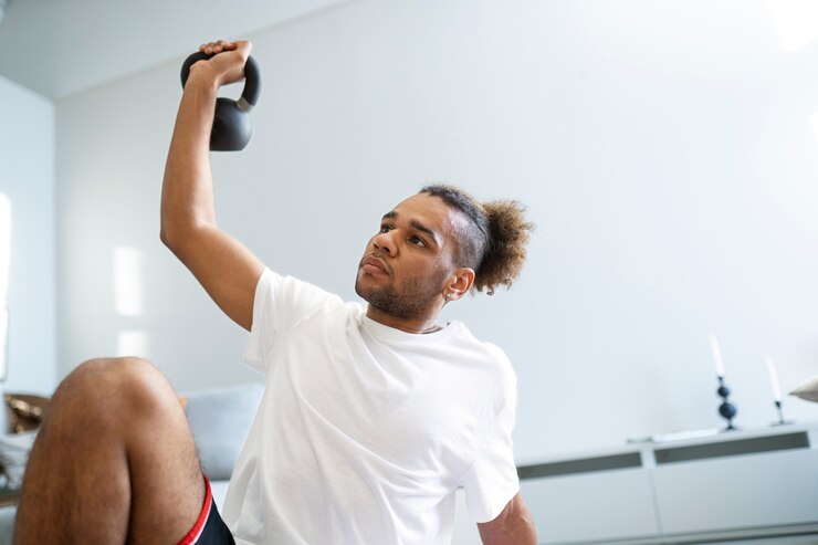 "Focused man lifting a kettlebell during workout, highlighting how On Take Water boosts energy levels, enhances strength, and supports peak performance."