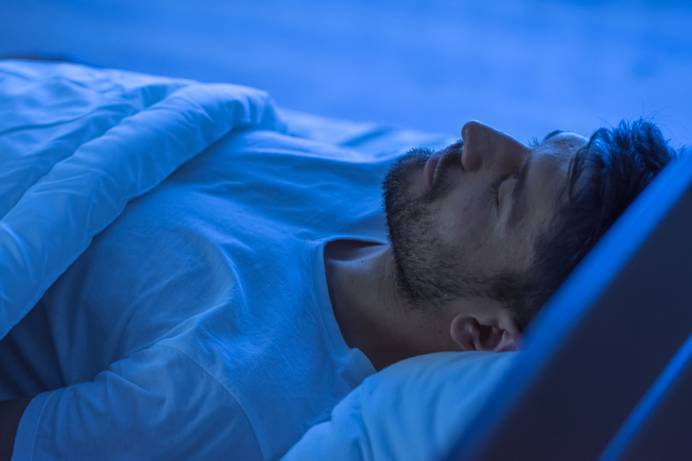 "Man sleeping peacefully at night, showing how On Take Water reduces night-time disruptions, supports deep rest, and improves overall sleep quality."